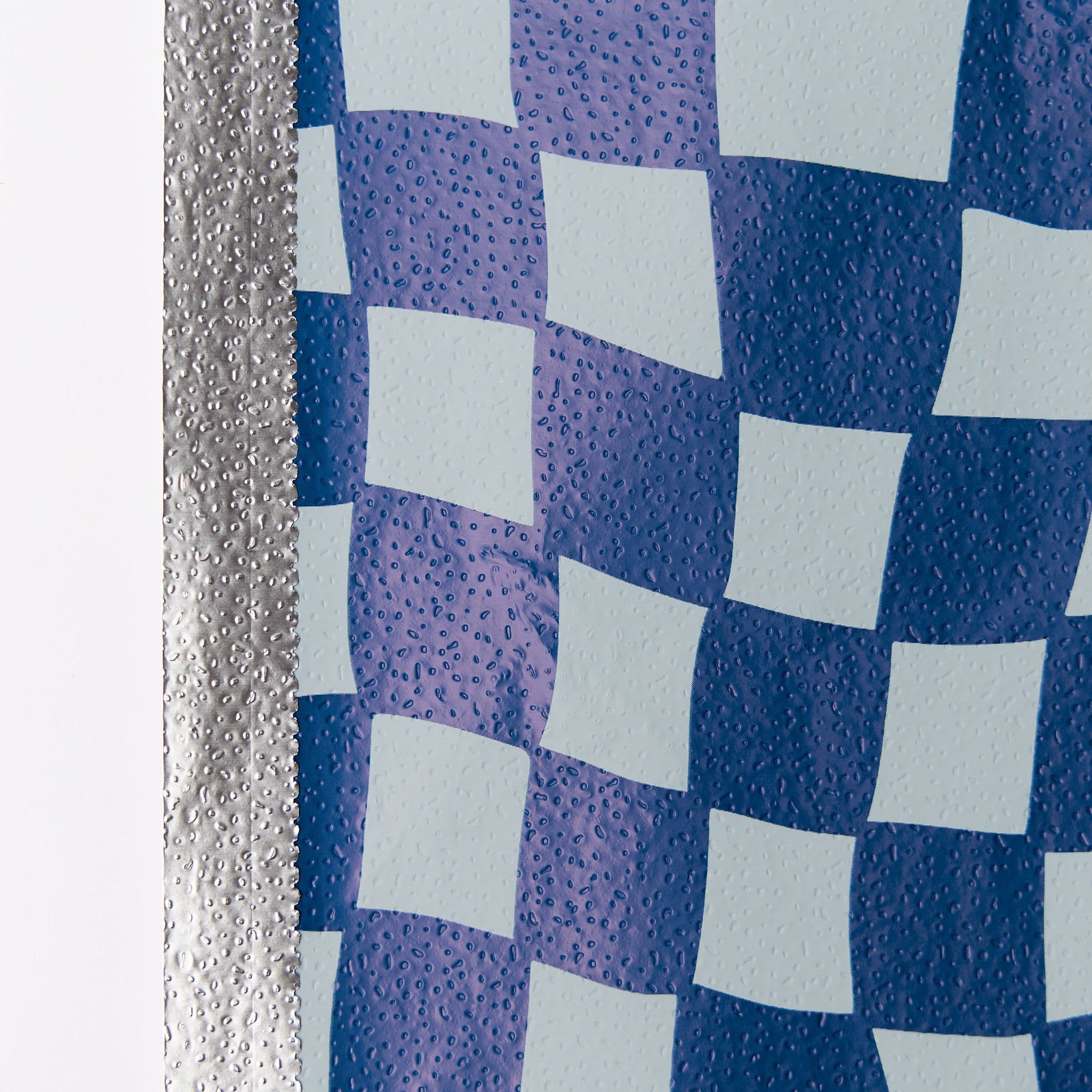 Close-up of Denim Check foil pattern and silver edge