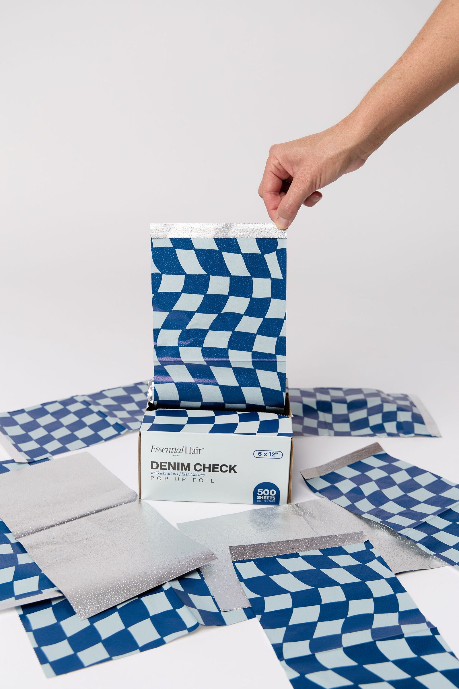 Denim Check foil box with hand pulling a foil